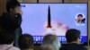 People watch a TV showing a news program reporting North Korea's missile launch, at the Seoul Railway Station in Seoul, South Korea, May 5, 2019.