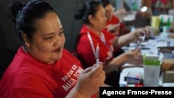 A photo taken and released by Matangi Tonga on Oct. 30, 2021, shows a Tongan nurse preparing to vaccinate people against COVID-19 inside Queen Salote Memorial Hall in Nuku'alofa. (Photo by Eleanor Gee)