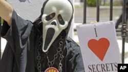 A protester holds a placard reading 'I Love Secrets' during a anti secrets bill protest at parliament in the city of Cape Town, South Africa, November 22, 2011.