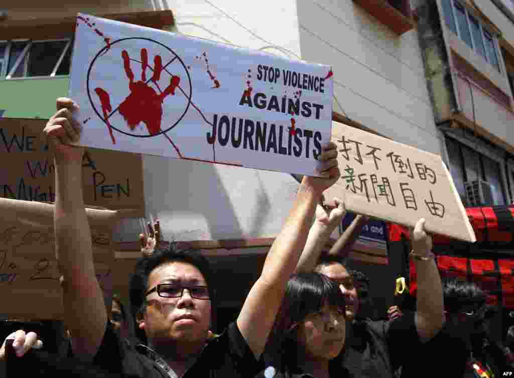 Members of the press hold placards during a rally to mark World Press Freedom Day in Kuala Lumpur, Malaysia, May 3, 2012.