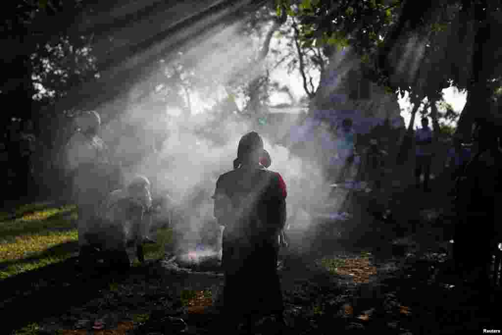People participate in a traditional ceremony to commemorate the victims of the 1932 Salvadoran peasant massacre, in Izalco, El Salvador, Jan. 22, 2018.