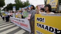 FILE - Protesters shout slogans during a rally to denounce deploying the Terminal High-Altitude Area Defense, or THAAD, in front of the Defense Ministry in Seoul, South Korea, Wednesday, July 13, 2016. President Park said North Korea's growing ballistic missile capabilities left the government no choice but to deploy the system.