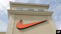 FILE - A Nike logo is displayed outside a Nike store in Charlotte, N.C., Sept. 4, 2018.