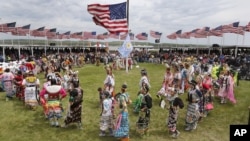 Native American dancers from more than 20 reservations in North and South Dakota perform before the arrival of President Barack Obama and first lady Michelle Obama on the Standing Rock Indian Reservation Friday, June 13, 2014, in Cannon Ball, N.D.