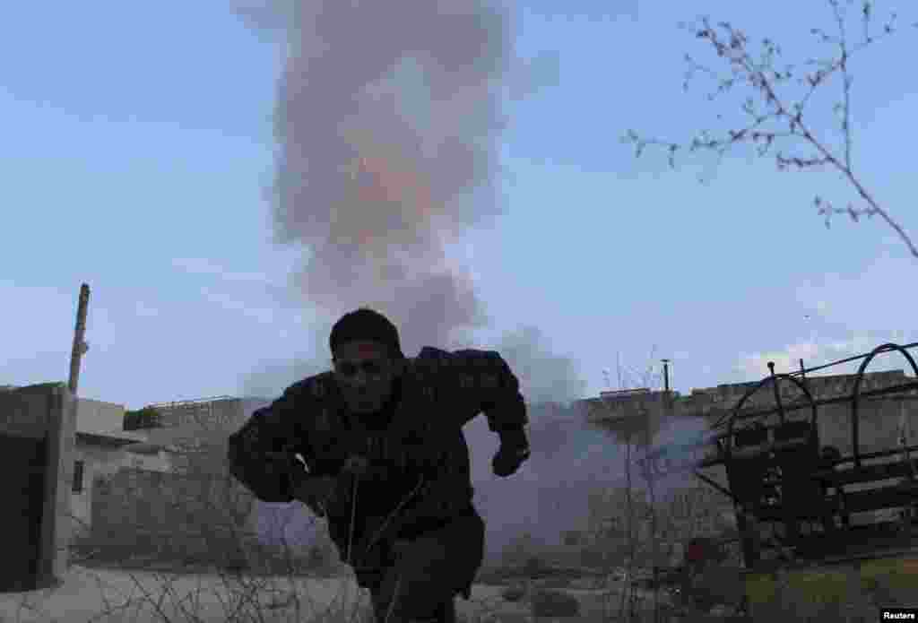 A Free Syrian Army fighter runs to take cover after firing a homemade mortar from Maaret al-Naaman town towards the Wadi al-Deif military base in Idlib, Nov. 5, 2013.