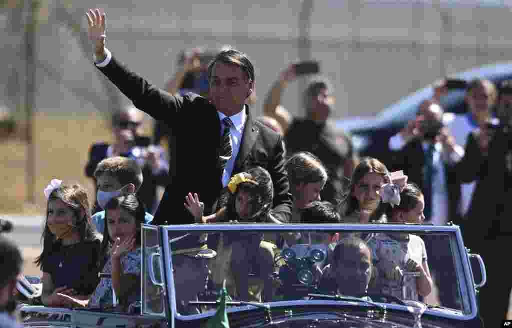 Brazil&#39;s President Jair Bolsonaro rides in an open car during an Independence Day event in Brasilia.