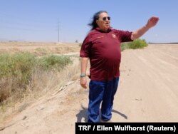 Cacique Jose Sierra, leader of the Ysleta del Sur Pueblo, visits the dried-up bed of the Rio Grande with the U.S.-Mexico border fence behind him in El Paso, Texas, May 21, 2018.