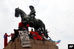 Opposition political parties gather by a statue of South African statesmen Louis Botha on the lawns of the Government Union Buildings in Pretoria, April 12, 2017.