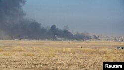 Smoke rises from clashes at Bartila in the east of Mosul during clashes with Islamic State militants, Iraq, Oct. 18, 2016. 