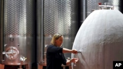 FILE - Cellar Master Elunda Basson works at the Steenberg vineyard in Constantia, Cape Town, South Africa, May 27, 2020. 