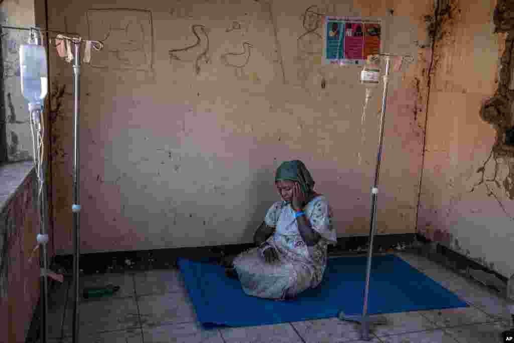 A Tigray woman who fled the conflict in Ethiopia's Tigray region, waits to get treatment at a clinic in Umm Rakouba refugee camp in Qadarif, eastern Sudan, Nov. 25, 2020.