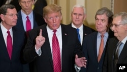 FILE - In this Jan. 9, 2019 photo, Sen. John Barrasso, R-Wyo., left, and Sen. John Thune, R-S.D., stand with President Donald Trump, Vice President Pence, Sen. Roy Blunt, R-Mo., and Senate Majority Leader Mitch McConnell, at the Capitol.