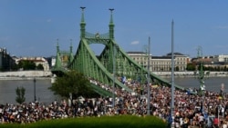 People march across the Szabadsag, or Freedom Bridge, over the River Danube during a gay pride parade in Budapest, Hungary, July 24, 2021.