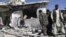 Afghans gather at the site of a bombing in Lashkar Gah, Helmand province, south of Kabul, October 8, 2012.
