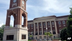 FILE - The Autherine Lucy Clock Tower at the Malone Hood Plaza stands in front of Foster Auditorium on the University of Alabama campus in Tuscaloosa, Ala., June 16, 2019. 