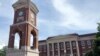 FILE - The Autherine Lucy Clock Tower at the Malone Hood Plaza stands in front of Foster Auditorium on the University of Alabama campus in Tuscaloosa, Ala., June 16, 2019. 