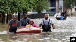 Residents are evacuated from their apartment complex surrounded by floodwaters in Houston, Texas, April 18, 2016.