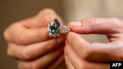 This photograph taken on Nov. 2, 2023 in Geneva, shows "Bleu Royal," a rare 17,61 carats internally flawless fancy vivid blue pear shaped diamond that sold for $43.8 million at a Christie's sale of rare jewels in Geneva on Tuesday.
