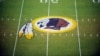 FILE - The Washington Redskins logo is shown on the field before the start of a preseason NFL football game against the New England Patriots in Landover, Md.