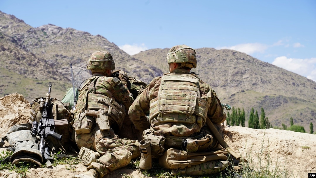 In this file photo taken on June 6, 2019 US soldiers look out over hillsides during a visit of the commander of US and NATO forces in Afghanistan General at the Afghan National Army (ANA) checkpoint in Nerkh district of Wardak province. 
