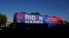 FILE - Democratic presidential candidate former Vice President Joe Biden and Democratic vice presidential candidate Sen. Kamala Harris, ride on a bus in Phoenix, Arizona, Oct. 8, 2020, on a small business bus tour. 