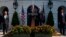 President Donald Trump delivers remarks about the economy on the South Lawn of the White House, July 27, 2018, in Washington. From left, Commerce Secretary Wilbur Ross, Trump, Vice President Mike Pence, and Treasury Secretary Steve Mnuchin.