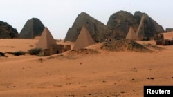 Tourists explore 44 Nubian pyramids of kings and queens in the ruins of the ancient city of Meroe next to Begrawiya, in the River Nile state of Sudan, March, 10, 2012. 