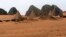Tourists explore 44 Nubian pyramids of kings and queens in the ruins of the ancient city of Meroe next to Begrawiya, in the River Nile state of Sudan, March, 10, 2012. 