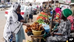 Idowu Bello, 56, shops for groceries in Ibadan, Nigeria, Sept. 13, 2024.