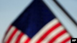 A US flag flutters above the Statue of Liberty in New York, which has become an iconic symbol of freedom and of the United States, (File)