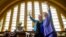 Democratic presidential candidate Hillary Clinton, accompanied by Sen. Elizabeth Warren, D-Mass., left, waves after speaking at the Cincinnati Museum Center at Union Terminal in Cincinnati, June 27, 2016.