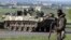 A Ukrainian soldier, supported by armoured personnel carriers, mans a checkpoint near the town of Slaviansk in eastern Ukraine May 3, 2014