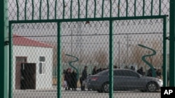 FILE - Residents line up inside a vocational training center in Artux, in western China's Xinjiang region, Dec. 3, 2018. Critics say China uses some of these facilities as detention camps for forced labor. 