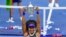 Naomi Osaka, of Japan, holds up the championship trophy after defeating Victoria Azarenka, of Belarus, in the women's singles final of the U.S. Open tennis championships, Sept. 12, 2020, in New York.