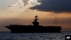 The U.S. aircraft carrier Theodore Roosevelt is anchored off Manila Bay to host top Philippine officials and businessmen in a cocktail reception Friday, April 13, 2018 west of Manila, Philippines. The aircraft carrier Theodore Roosevelt (CVN-71),…