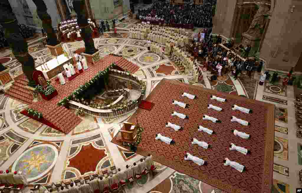 New priests lie face down on the floor during an ordination ceremony presided over by Pope Francis, in St. Peter&#39;s Basilica at the Vatican.