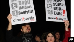 FILE - People shout slogans as they hold placards that read "stop censorship" during a rally in Ankara, Turkey, Jan. 18, 2014.