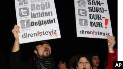 FILE - People shout slogans as they hold placards that read "stop censorship" during a rally in Ankara, Turkey.