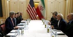 FILE - Then-US Secretary of State John Kerry (L) meets with Iranian Foreign Minister Mohammad Javad Zarif in Vienna, Jan. 16, 2016.