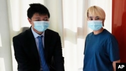 Wu Huan, right, and Wang Jingyu stand together in a safe house in the Ukraine on June 30, 2021. Wu claims that she was held for eight days at a Chinese-run “black site” in Dubai along with at least two Uyghurs.