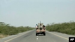 FILE - Saudi-backed forces, ride in their vehicle, in Hodeida, Yemen, Feb. 12, 2018. 