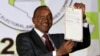 President-elect Uhuru Kenyatta displays the certificate from Independent Electoral and Boundaries Commission (IEBC) declaring him the winner of the country's presidential election in Nairobi, Mar. 9, 2013. 