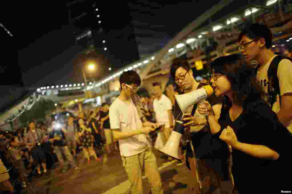 A student speaks as protesters block the main street to the financial Central district outside of the government headquarters building in Hong Kong Oct. 5, 2014.