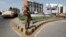 An army soldier stands guard on a road leading to a polling station during a re-polling for the general elections in Karachi, May 19, 2013. 