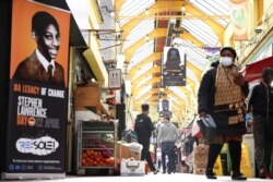 A general view of the exhibition 'Never Forget Stephen Lawrence', comprised of 29 flags installed in Brixton Village ahead of National Stephen Lawrence Day, in London, April 21, 2021.