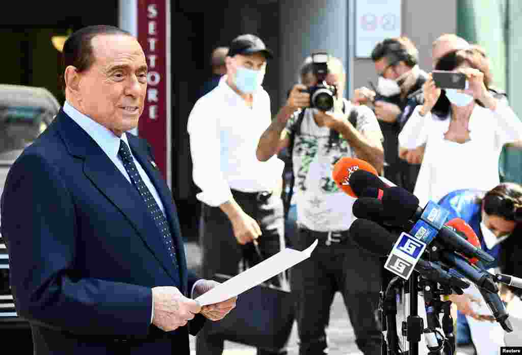 Former Italian Prime Minister Silvio Berlusconi speaks to the media as he leaves Milan&#39;s San Raffaele hospital, where he was being treated after testing positive for the COVID-19 and diagnosed with mild pneumonia, in Milan.