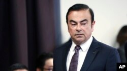 FILE - In this May 12, 2016, file photo, then Nissan Motor Co. President and CEO Carlos Ghosn arrives for a joint press conference with Mitsubishi Motors Corp. in Yokohama, near Tokyo.