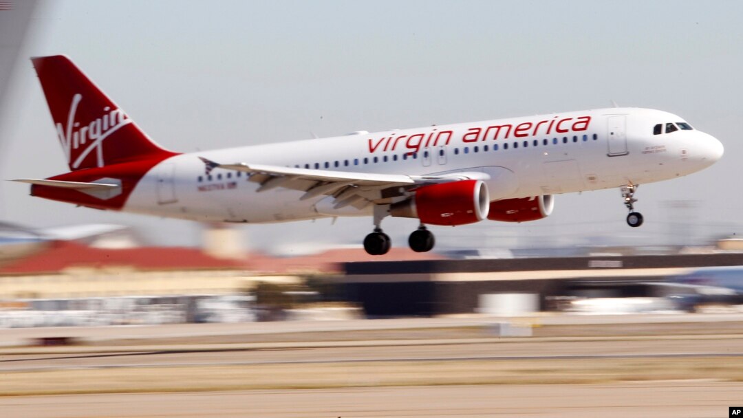 FILE - A Virgin America's flight between Los Angeles and Dallas is seen coming in for a landing at Dallas Fort Worth International Airport in Grapevine, Texas, Dec. 1, 2010. Alaska Air Group Inc. is eyeing to buy Virgin America in a deal valued at $4 bill