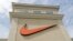FILE - A Nike logo is displayed outside a Nike store in Charlotte, N.C., Sept. 4, 2018.