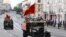 Participants wearing historical uniforms ride in the back of a WWII-era truck during a military parade, which marks the 75th anniversary of the Soviet victory over Nazi Germany in World War Two, in the far eastern city of Vladivostok on June 24, 2020.